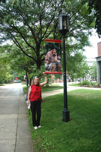 Designer Chris Justice poses with one of her creations on Appian Way.