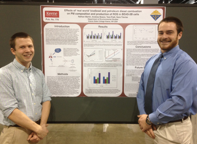Research Associate Nathan Martin (left) and chemistry and education double major Andrew Bosco presenting their poster at the ACS National Meeting