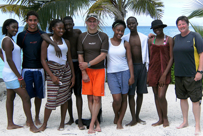 Scott Strong (center, in orange shorts) and Karen Cangialosi (far right) with local students on Providenciales