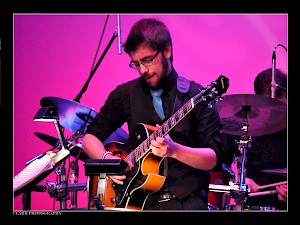 A guitar student performs a solo during the Jazz Ensemble concert.