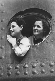 Jewish refugees peer from a porthole in the MS St. Louis while the ship waited in the port of Havana