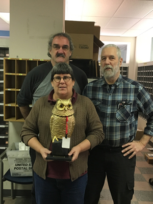 Elizabeth Clark, Michael Dwyer, and Dana Gibson receive the Golden Owl. Photo by Barbara Preston