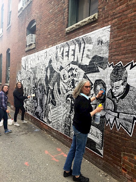 Rosemarie Bernardi and students install their mural in downtown Keene. Photo by Heather McGreer.