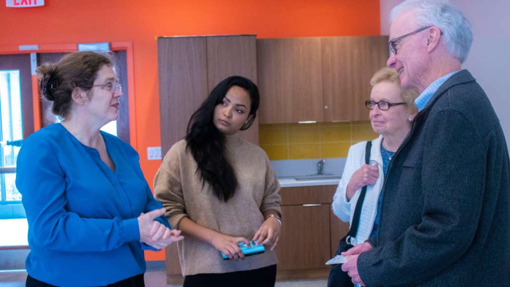 Professor Duggan, left, talks with student Puja Thapa and Mary and Bob Rooney. Puja interviewed Bob Rooney for her course blog.