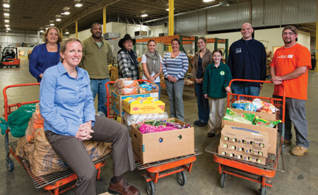 Mel Gosselin '90 with some of her staff at the New Hampshire Food Bank. Photo by John W. Hession.