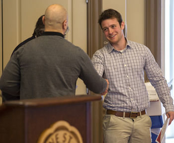 Senior Brian Cantore receiving his SCJ award from Equinox co-advisors Julio DelSesto and Rodger Martin.