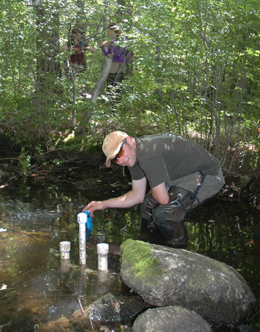 Charles Stoll gathers data logger downloads for Prof. Burchsted's EPSCoR research project. (Photo by Mark Reynolds)