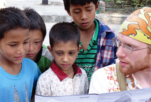 Keene State student Matt McDougal '15 talks with local children during a Morris-August Honors Program trip to Nepal. Courtesy photo