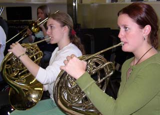 Left to right: Emma Real and Danielle Discenzoplaying horns in Keene States Concert Band