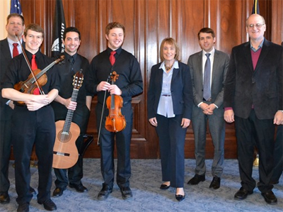 (L–R): Jonathan Way, Jordan Chase, Dan Ciccorello (with instruments), Maggie Hassan (center), José Lezcano (far right)