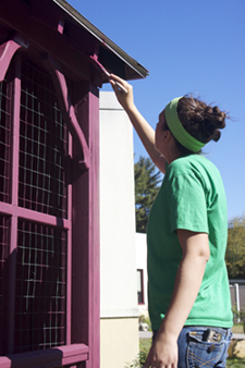 Chamber singer Sheryl Magdycz sprucing up the paint at MHS