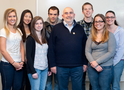 Bruce LeVine Mellion (center), surrounded by a few of the many students he's supported