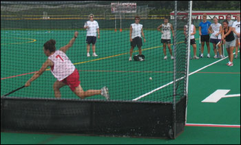 Junior Lindy Caslin makes a defensive save during field hockey practice