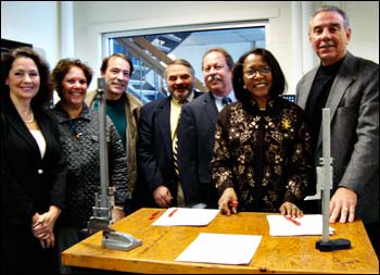 L-R: Senator Molly Kelly, Susan B. Newcomer (Greater Keene Chamber of Commerce), Vic Kissell (Tidland Corporation), William B. Gurney (SAU 29), Steven G. Budd (River Valley Community College), Helen F. Giles-Gee (Keene State College), and Thomas Dowling (Greater Keene Chamber of Commerce) stand next to a rapid prototype machine at Keene State College. The Regional Center for Advanced Manufacturing (RCAM) was officially launched on February 12, 2010.