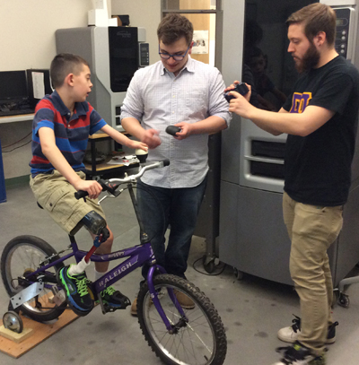 Nicholas Cusack gives his feedback on the final tweaks for his bike with SPDI designers Alex Delcore (middle) and Peter Solek.