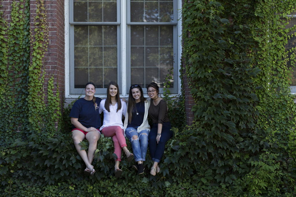 Students sit in the ivy of a Parker Hall window. Photo by Will Wrobel.