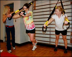 Olympic Coach Lori Briggs works with Owl swimmers Sheila Cremin and Meghan Wilson