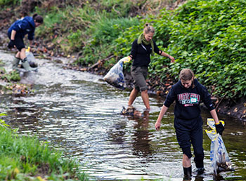 Students remove trash and debris from the Ashuelot River.