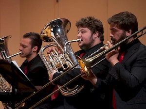 Students perform on brass instuments.