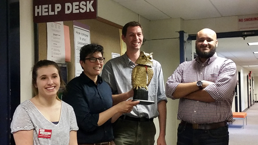 Callie Grotton, Elise Morrissette, Brendan Kelley, and Rob Coleman from the HelpDesk accept the Golden Owl.