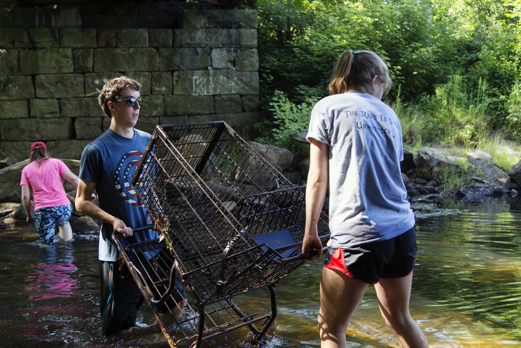First-year students pull debris from the Asheulot River during this summer's PreServe program.
