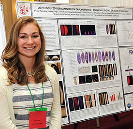 Haley Zanga with her Best Poster Award presentation, “Light-Induced Depigmentation in Planarians – An Animal Model of Acute Porphyrias”