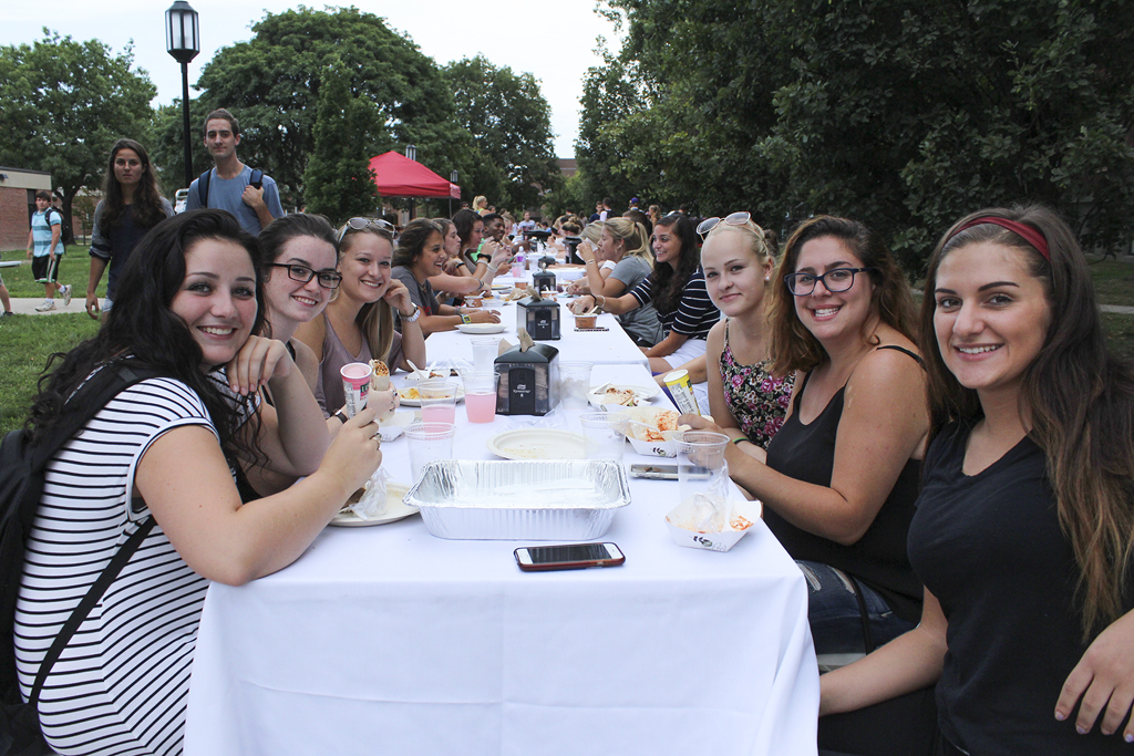 Students enjoy the campus dinner on Appian Way. Photo by Lynn Roman