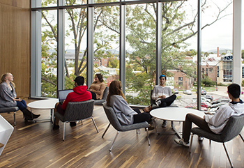 Students interact with each other in one of the new Living Learning Commons' open spaces.