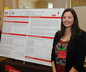 Emily Wollert giving a poster presentation