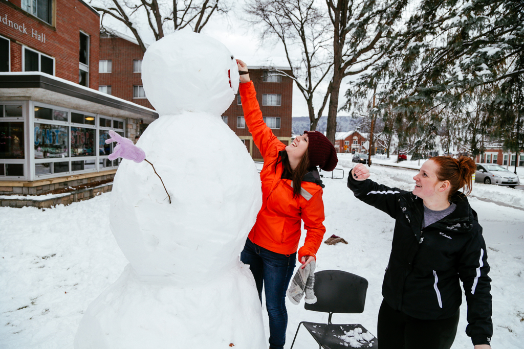 Students build a snowman outside Monadnock Hall. Photo by Will Wrobel