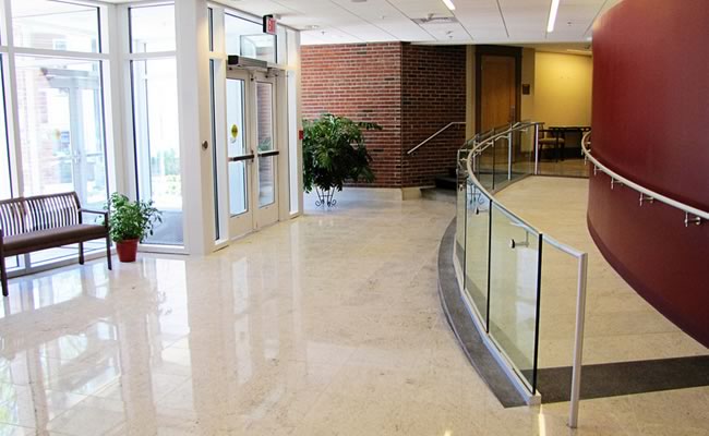 Guests enter the building through a light-filled reception gallery.