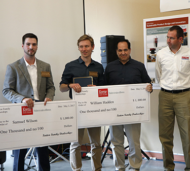 (Left to right) Samuel Wilson and William Hadden receive big scholarship checks from Fenton representatives Bob Swartz and George Thompson.