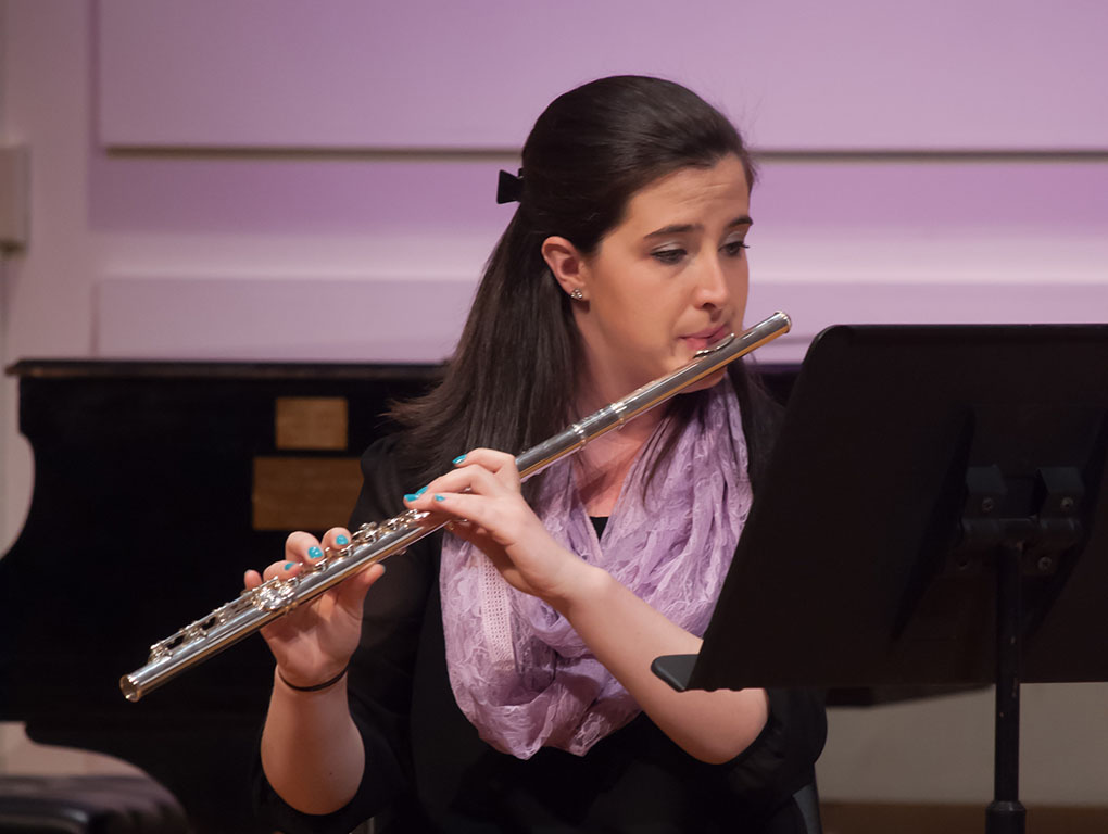 A flute players performs with the String Ensemble.