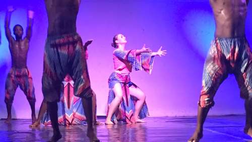 Olivia Miller performing with Ghanaian dancers