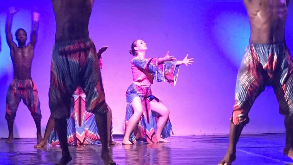Olivia Miller performing with Ghanaian dancers