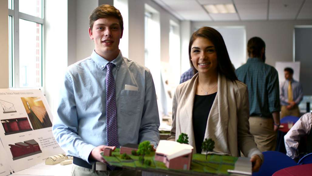 Logan Mott and Kayla Gallo display their model for an addition to the Tunga Primary School in Malawi.