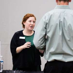 Hannah (Hayes) Hartzsch ’11 talks with a student at Your Career Fair