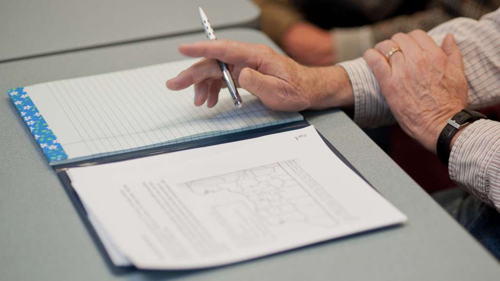 Person taking notes in classroom