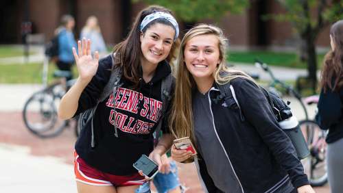 Students waving on Appian Way Fall