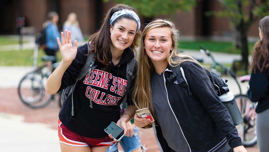 Students waving on Appian Way Fall