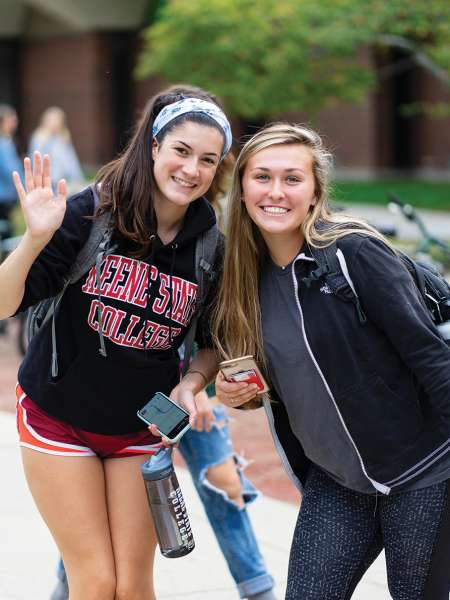 Students waving on Appian Way Fall