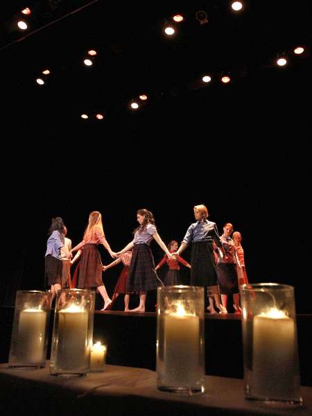 Dancers with candles in the foreground.