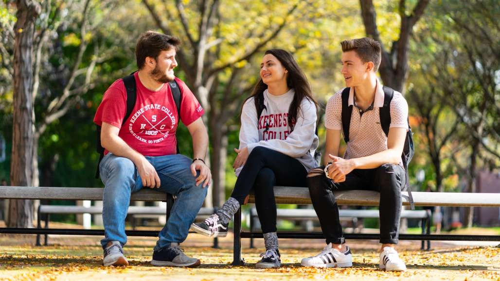 Students on Bench in the Fall