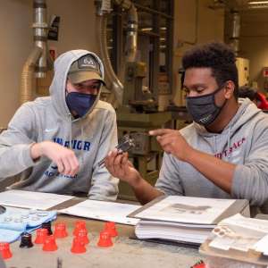 Two students during a machining class at Keene State