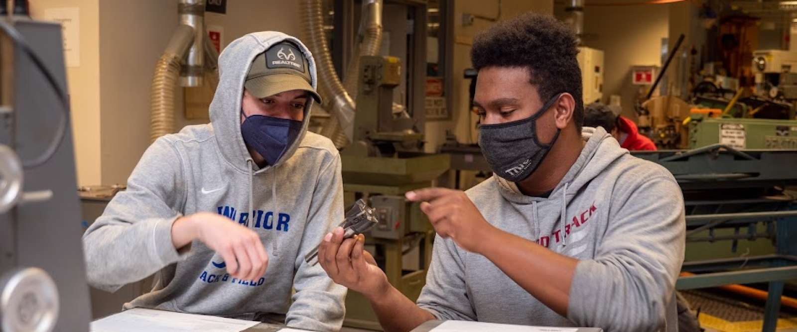 Two students during a machining class at Keene State