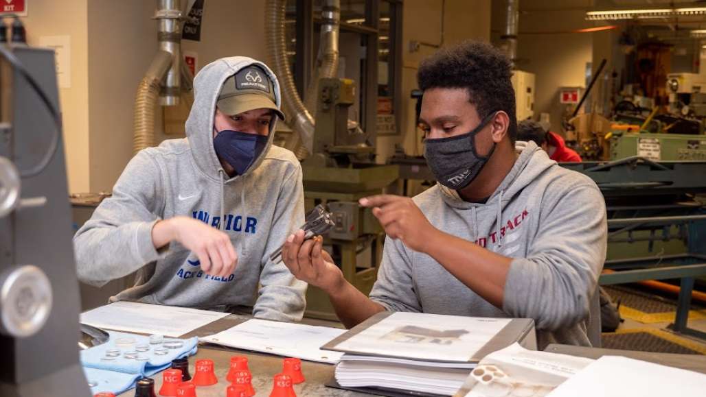 Two students during a machining class at Keene State