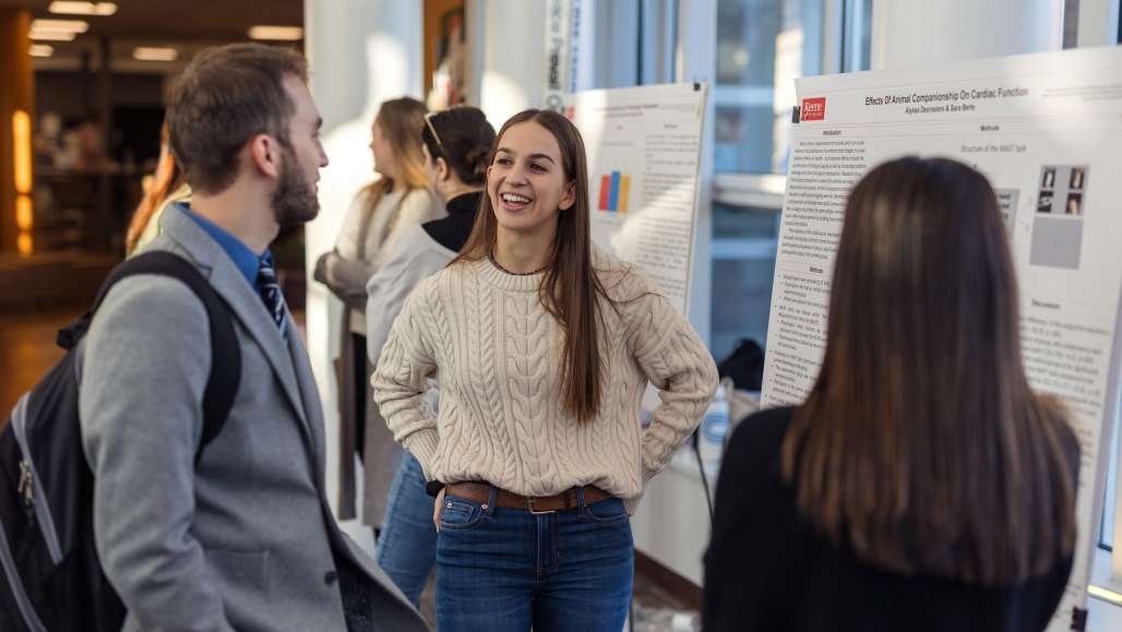 Students present during a poster presentation at the Winter Academic Showcase