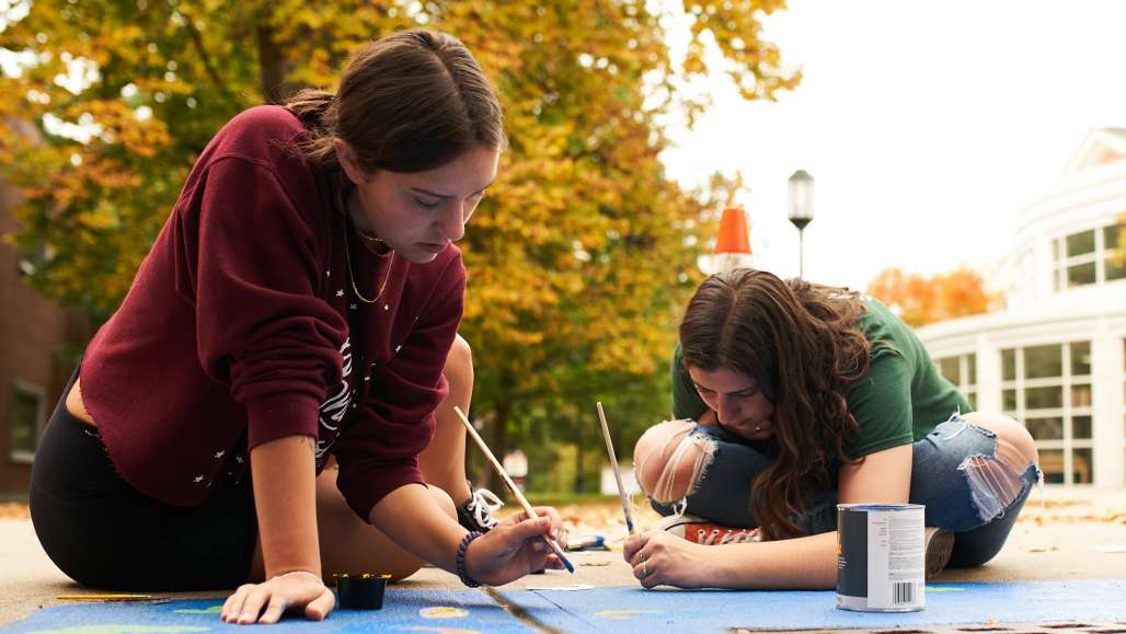 Students creating sustainability mural