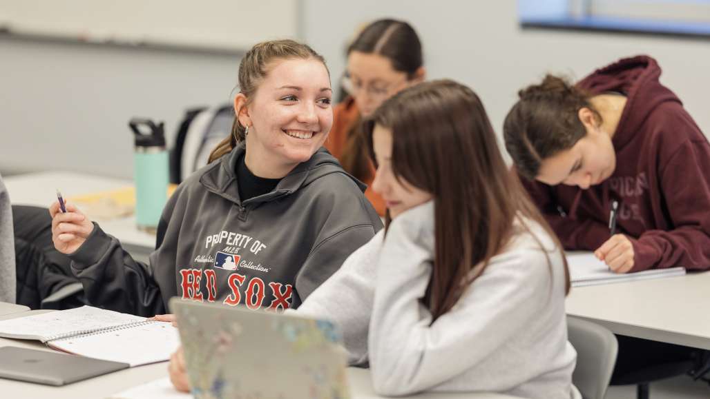 Students smile in a classroom