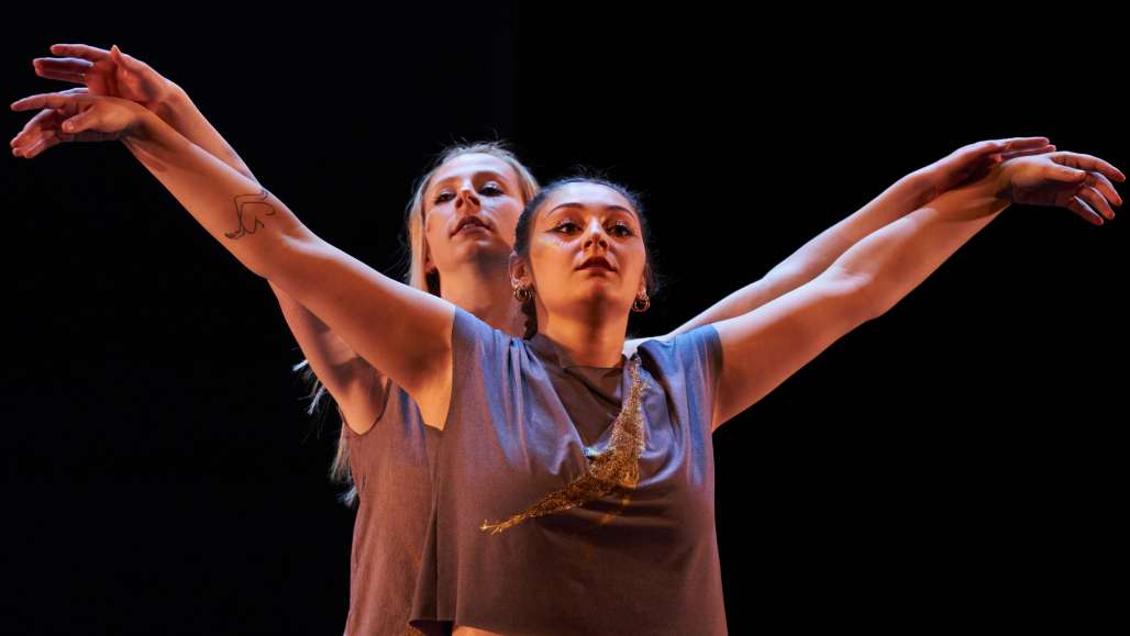 Two female dancers perform on stage during Evening of Dance